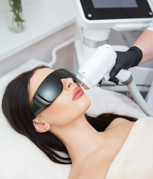The process of laser hair removal of the female body. Professional cosmetology